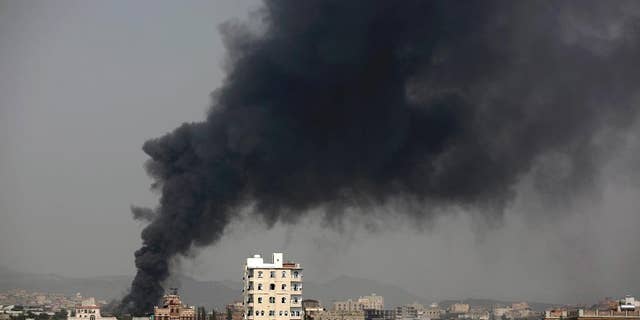 In this Aug. 9, 2016 photo, smoke rises after Saudi-led airstrikes hit a food factory in Sanaa, Yemen. In the air campaign by Saudi Arabia and its allies against Yemen’s Shiite rebels, rights experts say there has been a pattern by the Saudi-led coalition in depending on faulty intelligence, failing to distinguish between civilian and military targets and disregarding the likelihood of civilian casualties. Experts say some of the strikes likely amount to war crimes. (AP Photo/Hani Mohammed)