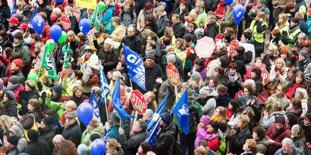 Teacher join al rally in a bid to receive higher wages and preserve pension benefits in Leipzig, Germany, Wednesday, March 11, 2015. The ver.di union said besides teachers other public employees including police and firefighters walked off the job in multiple states in Germany. (AP Photo/dpa, Peter Endig)