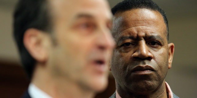 Feb. 18, 2015: Kelvin Cochran, right,who was fired from his position as Atlanta Fire Chief, listens as his attorney David Cortman answers questions at a press conference where he and his attorney announced that they had filed a federal lawsuit against the City of Atlanta.