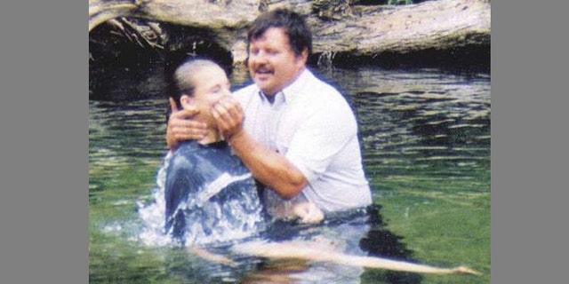 Pastor Jim Privett of Gladden Baptist Church performs a baptism in a Missouri creek.