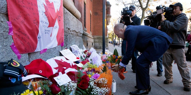 Oct. 23, 2014: Bruce Heyman, the American Ambassador to Canada, places flowers at a makeshift memorial to Cpl. Nathan Cirillo outside of The Lieutenant-Colonel John Weir Foote Armoury in Hamilton, Ontario.