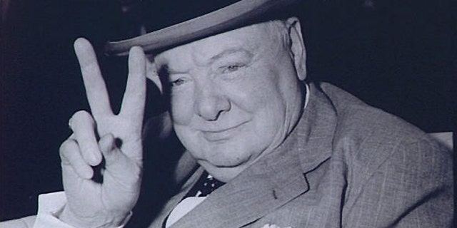 FILE -- May 25, 1954: Winston Churchill, British Prime Minister, gives V for Victory sign arriving in Washington, DC.