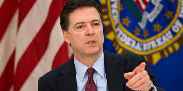 FILE - March 25, 2015: FBI director James Comey as he gestures during a news conference at FBI headquarters in Washington.