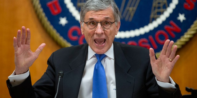 FILE -- Feb. 26, 2015: Federal Communications Commission (FCC) Chairman Tom Wheeler gestures near the end of a hearing for a vote on Net Neutrality at the FCC in Washington. Internet activists scored a major victory after the Federal Communications Commission agreed to rules that would ban service providers from creating Internet fast lanes.