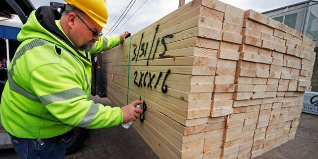 March 31, 2015: Roy Livesey marks a pallet of 2x4's at the Allegheny Millwork and Lumberyard in Pittsburgh. The Commerce Department releases first-quarter gross domestic product on Wednesday, April 29, 2015.