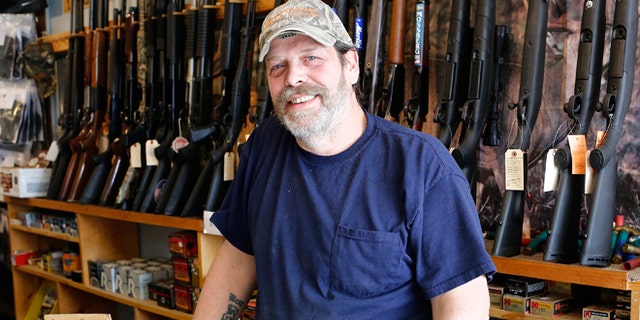 FILE -- March 31, 2015: Shooter's Paradise owner Paul Barrett stands inside his store in Sioux City, Iowa.