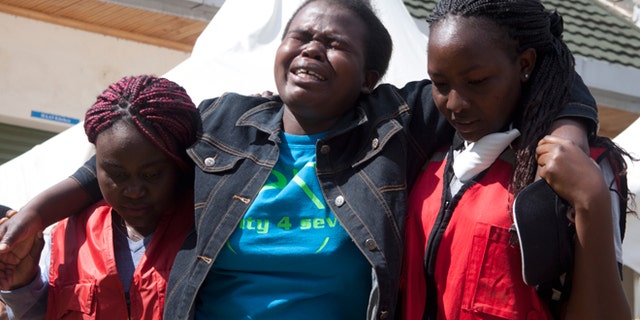 April 8, 2015: Kenya Red Cross staff help a woman after she viewed the body of a relative killed in last Thursday's attack on Garissa University College in northeastern Kenya, at Chiromo funeral home, Nairobi, Kenya. Al-Shabab gunmen rampaged through the university at dawn Thursday, killing over 140 people in the group's deadliest attack in the East African country.