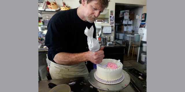 File: March 10, 2014: Masterpiece Cakeshop owner Jack Phillips decorates a cake inside his store, in Lakewood, Colo.