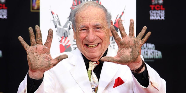 FILE -- Sept. 8, 2014: Director/Comedian Mel Brooks displays his cement-covered hands, including one with a prosthetic finger, during his Hand and Footprint ceremony marking the 40th anniversary of the movie "Young Frankenstein," in front of the TCL Chinese Theatre in the Hollywood section of Los Angeles.