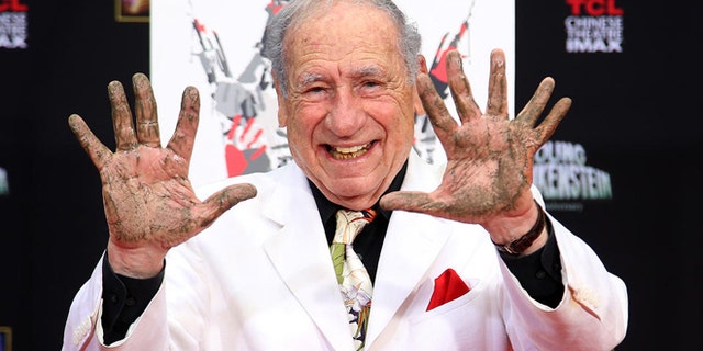 FILE -- Sept. 8, 2014: Director/Comedian Mel Brooks displays his cement-covered hands, including one with a prosthetic finger, during his Hand and Footprint ceremony marking the 40th anniversary of the movie "Young Frankenstein," in front of the TCL Chinese Theatre in the Hollywood section of Los Angeles.