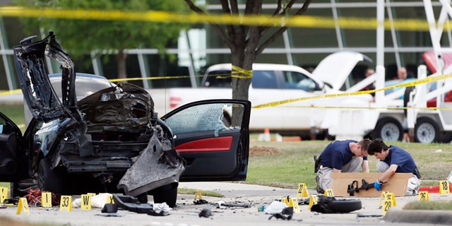 May 4, 2015: Investigators box up an assault weapon outside the Curtis Culwell Center in Garland, Texas. Two men opened fire with assault weapons on police Sunday night who were guarding a provocative contest for Prophet Muhammed cartoons. A police officer returned fire killing both men.