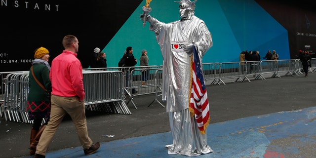 Dec. 30, 2014: A costumed character dressed as the Statue of Liberty stands in a quiet area of Times Square in New York.