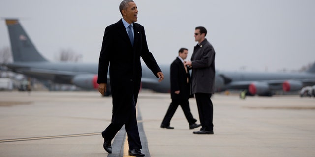 Jan. 22, 2015: President Obama walks to board Air Force One at Forbes Field Airport in Topeka, Kansas, en route to Washington, after speaking at the University of Kansas in Lawrence, Kansas.