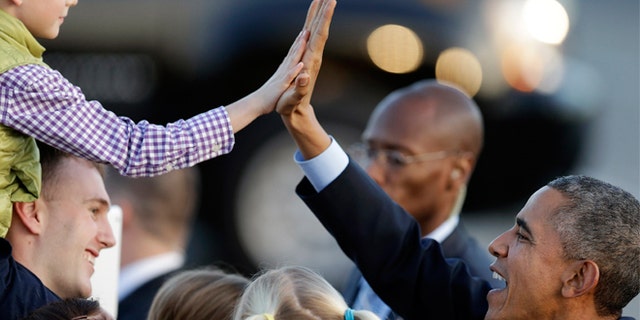 Feb. 12, 2015: President Obama high five's a boy upon his arrival at San Francisco International Airport in San Francisco.
