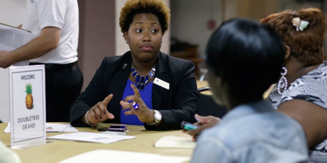 Jan. 23, 2015: Natalie Parker, director of human resources at the Doubletree Grand, left, talks with job applicants during a job fair at the Hospitality Institute.