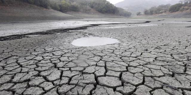 Feb. 7, 2014: This file photo shows the cracked-dry bed of the Almaden Reservoir in San Jose, Calif.