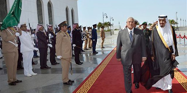 FILE -- Oct. 7, 2013: In this photo released by the Saudi Press Agency, Defense Minister and Saudi Crown Prince Salman bin Abdul-Aziz, right, welcomes Egyptian interim President Adly Mansour on his arrival to the airport in Jiddah, Saudi Arabia. Egypt's interim president has landed in Saudi Arabia for his first foreign trip since assuming power after the ouster of the country's Islamist president.