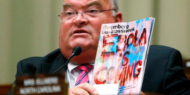 U.S. Representative Billy Long (R-MO) holds up a copy of a magazine with an Ebola headline as public health officials testify before a House Energy and Commerce Oversight and Investigations Subcommittee hearing on the U.S. response to the Ebola crisis, in Washington October 16, 2014. REUTERS/Jonathan Ernst