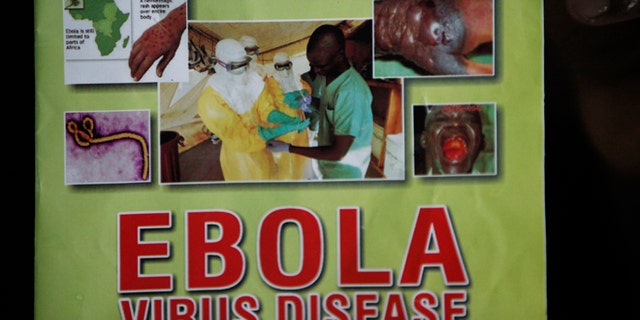 Nigeria health official display a leaflet explaining Ebola Virus Disease at the arrival hall of Murtala Muhammed International Airport in Lagos, Nigeria, Monday, Aug. 4, 2014. Nigerian authorities on Monday confirmed a second case of Ebola in Africa's most populous country, an alarming setback as officials across the region battle to stop the spread of a disease that has killed more than 700 people. (AP Photo/Sunday Alamba)