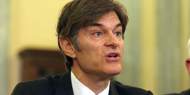 In this June 17, 2014, file photo, Dr. Mehmet Oz, vice chairman and professor of surgery, Columbia University College of Physicians and Surgeons, testifies on Capitol Hill in Washington. Ten top physicians want Columbia University to remove the celebrity doctor from his medical faculty position. They cite what they call the heart surgeon's "egregious lack of integrity" as host of a television program where he promotes weight loss products.