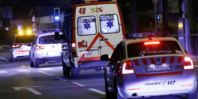 An ambulance (2R) carrying Cuban doctor Felix Baez leaves Cointrin airport in Geneva November 21, 2014. A Cuban doctor, identified by Cuban officials as Felix Baez, who was infected with Ebola in Sierra Leone, was flown to Switzerland for treatment at the University Hospital in Geneva (HUG). Baez is one of 165 Cuban doctors and nurses treating Ebola patients in Sierra Leone and is the first of the group, deployed since early October, who is known to be infected by the virus that has killed more than 5,400 people.