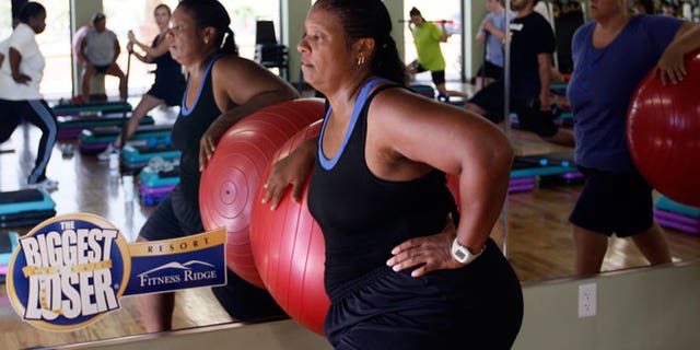 Guest Stacey Scott works out with a stability ball in a "total toning" class at the Biggest Loser Resort in Ivins, Utah September 7, 2010. Guests at the resort affiliated with the popular reality television show eat about 1,200 calories a day but burn over 2,000 exercising 6 - 7 hours daily.