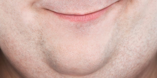Extreme closeup portrait of an overweight man's face with funny expression
