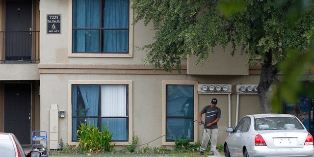 Oct. 2, 2014: A worker washes the sidewalk in front of the apartment unit at The Ivy Apartments, where a man diagnosed with the Ebola virus was staying in Dallas. (REUTERS/Mike Stone)