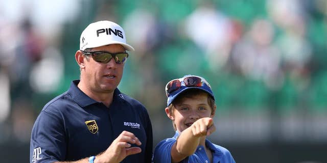 Lee Westwood of England and his son Sam look along the 4th fairway during a practice round ahead of the British Open Golf championship at the Royal Liverpool golf club, Hoylake, England, Tuesday July 15, 2014. The British Open Golf championship starts Thursday July 17. (AP Photo/Scott Heppell)
