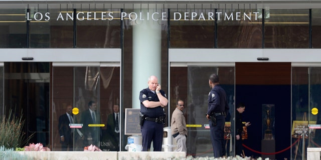 LAPD officers are deployed around the police headquarters on February 7, 2013 in Los Angeles.
