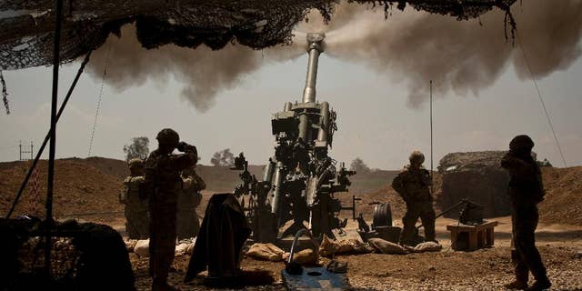 U.S. soldiers from the 82nd Airborne Division fire artillery in support of Iraqi forces fighting Islamic State militants from their base east of Mosul on Monday, April 17, 2017. The soldiers are from C Battery, 2nd Battalion, 319th Airborne Field Artillery Regiment. (AP Photo/Maya Alleruzzo)