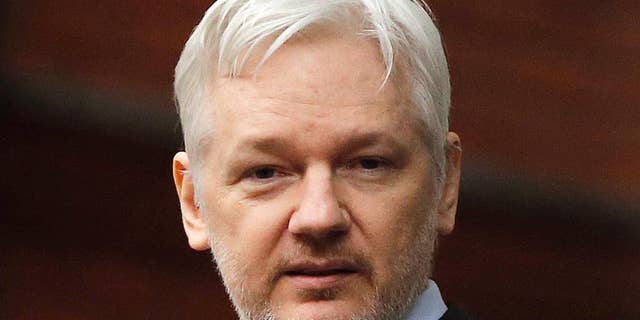 FILE - In this Feb. 5, 2016, file photo, WikiLeaks founder Julian Assange stands on the balcony of the Ecuadorean Embassy in London. Assange is celebrating the results of Ecuador’s presidential runoff with a blast at the losing candidate who had pledged to evict him from Ecuador’s embassy in London. Assange has been holed up at the diplomatic mission since 2012, when President Rafael Correa granted him asylum. (AP Photo/Frank Augstein, File)