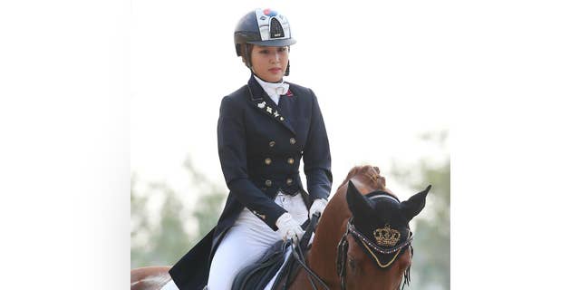 In this photo taken on Sept. 20, 2014, South Korea's Chung Yoo-ra, the daughter of Choi Soon-sil, the confidante of disgraced President Park Geun-hye, competes during the equestrian dressage team competition for the 17th Asian Games in Incheon, South Korea. South Korean prosecutors said Monday, Jan. 2, 2017, Chung has been arrested in Denmark and authorities are working to get her returned home in connection with a huge corruption scandal. (Lee Sang-hak/Yonhap via AP)