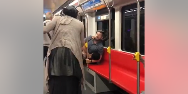 A video posted to Twitter Thursday shows a man appearing to headlock a juvenile aboard the Muni train.