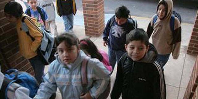 ** ADVANCE FOR WEEKEND OF MARCH 19-20 **Students make their from their buses to school at the Lyman Hall Elementary school in Gainesville, Ga., Wednesday, Feb. 23, 2005. Lyman Hall Elementary is listed as 94 percent Hispanic. (AP Photo/Ric Feld)