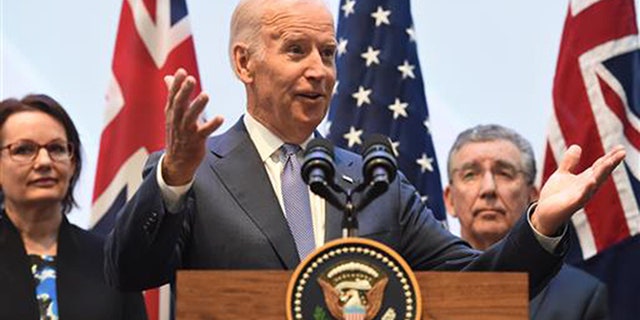 U.S. Vice President Joe Biden, center, speaks to guests with Health Minister Susan Ley, left, and Professor Jim Bishop after a tour of the Victorian Comprehensive Cancer Centre in Melbourne, Sunday, July 17, 2016. Biden attended the opening of Victoria's $1 billion Comprehensive Cancer Centre while on his four day visit to Australia.(Tracey Nearmy/Pool Photo via AP)