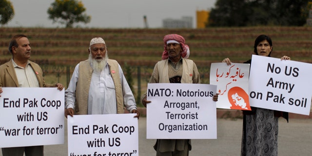 Dec. 1: Pakistanis hold placards and chant slogans during a protest to condemn NATO helicopters attacks on Pakistani troops, in Islamabad, Pakistan.