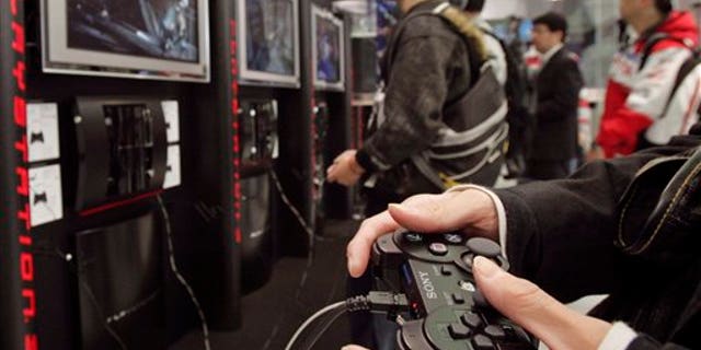 FILE - In this Nov. 9, 2006 file photo, visitors at the Sony Building in downtown Tokyo play Sony's next-generation video game PlayStation 3 as its two-week-long free trial service goes on. Sony Corp. said Tuesday, April 26, 2011 that the credit card data of PlayStation users around the world may have been stolen in a hack that forced it to shut down its PlayStation Network for the past week, disconnecting 77 million user accounts. (AP Photo/Katsumi Kasahara, File)