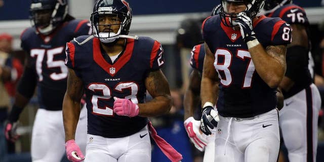 Houston Texans' Arian Foster (23) and C.J. Fiedorowicz (87) run back to the sideline after Foster ran the ball in for a touchdown against the Dallas Cowboys during the second half of an NFL football game, Sunday, Oct. 5, 2014, in Arlington, Texas. (AP Photo/Tim Sharp)