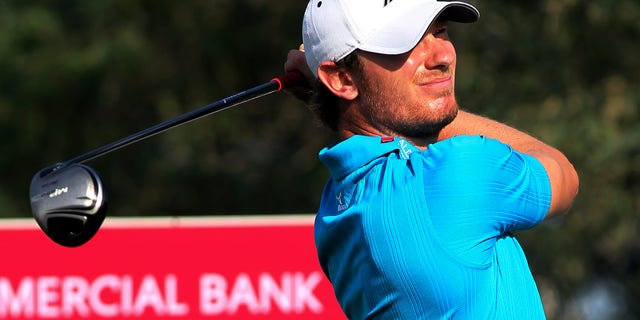 Chris Wood of England plays his shot on the 18th hole during the third round of the Commercial Bank Qatar Masters held at the Doha Golf Club in Qatar, Friday, Jan. 25, 2013. (AP Photo/Osama Faisal)