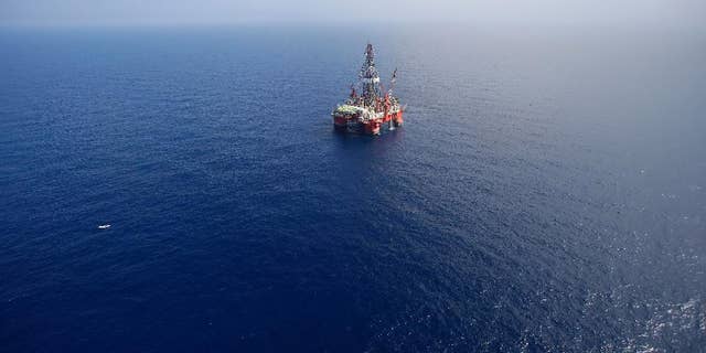 FILE - In this Nov. 22, 2013, file photo, the Centenario deep-water drilling platform stands off the coast of Veracruz, Mexico in the Gulf of Mexico. Mexico's government announced on Thursday, Dec. 11, 2014 the start of bidding for oil exploration rights in 14 areas of the Gulf of Mexico being opened to domestic and international companies as it ends a seven-decade state monopoly on the petroleum business. (AP Photo/Dario Lopez-Mills, File)