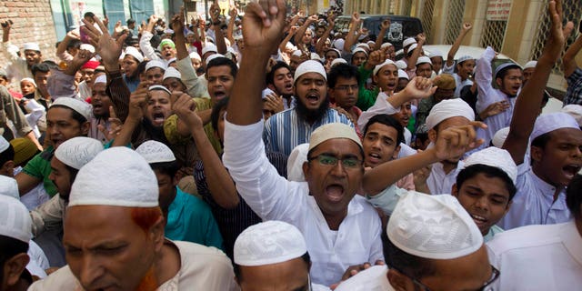 Activists of Hifazat-e Islam shout slogans during a rally in support of the Long March, a march from Chittagong to Dhaka, in Dhaka, Bangladesh, Friday, April 5, 2013. A number of activists under the banner of Hifazat-e Islam are set to start their long march from Chittagong to Dhaka Saturday on foot to protest against Bangladeshi bloggers who they allege are hurting religious sentiments of the country's Muslim majority. (AP Photo/A.M. Ahad)
