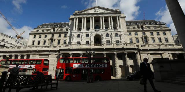 FILE - In this Friday, June, 24, 2016 file photo, Buses pass the Bank of England, in the City of London. Britain's leading stock index has struck a record high as a closely monitored survey showed manufacturers in the country expanding at their highest tick in 30 months. By late-morning Tuesday, Jan. 3, 2017 the FTSE 100 index was up 0.3 percent at 7,165. Earlier in the session, it had breached the 7,200 mark for the first time ever, trading as high as 7,205.21. (AP Photo/Matt Dunham, File)