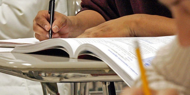 Students work out math problems during a class for Hispanic adults, Wednesday, March 16, 2005, at Cary High School in Cary, N.C. Even among Hispanics 16-to-19 who were educated entirely in the United States, 15 percent nationally are dropouts, compared with 12 percent for blacks and 8 percent for whites. (AP Photo/ Karl DeBlaker)