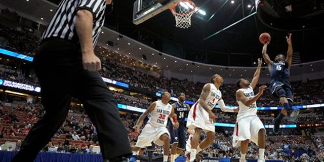 March 24: Connecticut's Kemba Walker (15) shoots over San Diego State's Chase Tapley, Malcolm Thomas (4), Billy White (32) during the first half of a West regional semifinal in the NCAA college basketball tournament in Anaheim, Calif. (AP)
