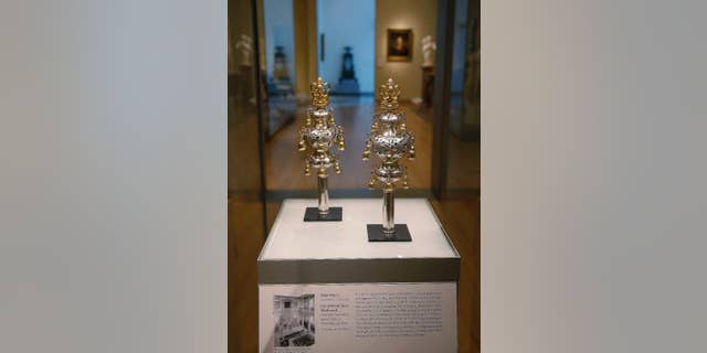 FILE - In this June 1, 2015, file photo, ceremonial bells belonging to the 250-year-old Touro Synagogue in Newport, R.I., and worth more than $7 million are on display at the Museum of Fine Arts in Boston. A federal judge overseeing a trial over control of the nation’s oldest synagogue and ceremonial bells said on Friday, Sept. 18, there is no “smoking gun,” in the battle between the congregation that worships at the 250-year-old Touro Synagogue in Newport and the nation's first Jewish congregation, in New York. (AP Photo/Stephan Savoia, File)