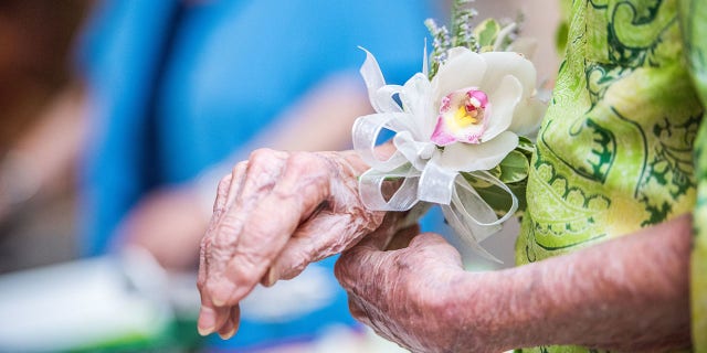 Surrounded by family, friends and airline staffers, Harmon was presented with an orchid in a Delta tradition.