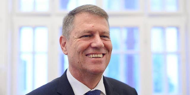 Klaus Iohannis, leader of Romania's center-right Liberals and mayor of the Transylvanian city of Sibiu, smiles while posing for a portrait, shortly after giving an interview to the Associated Press, on the first morning after exit polls in the presidential elections runoff in Bucharest, Romania, Monday, Nov. 17, 2014. The ethnic German mayor who defeated Romania's Prime Minister Victor Ponta in a presidential runoff said his victory signaled "a deep change" in Romania. (AP Photo/Octav Ganea, Mediafax) ROMANIA OUT