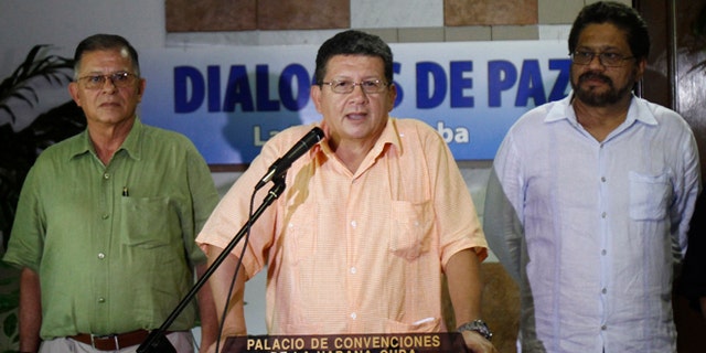 Pablo Catatumbo, chief of the western bloc of the Revolutionary Armed Forces of Colombia, or FARC, center, speaks to journalists accompanied by Ricardo Tellez, left, and Ivan Marquez, chief FARC negotiator during peace talks with Colombia's government in Havana, Cuba, Friday, Aug. 23, 2013. Colombia's largest guerrilla army temporarily walked away from peace talks with the government Friday over President Juan Manuel Santos' refusal to agree to modify the constitution if a peace pact is struck. (AP Photo/Ismael Francisco, Cubadebate)