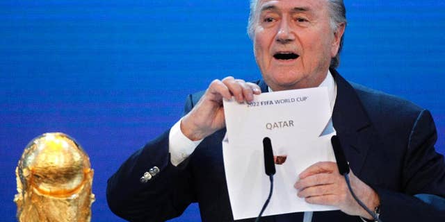 FILE - In this Thursday, Dec.2, 2010 file photo FIFA President Sepp Blatter announces Qatar to host the 2022 soccer World Cup in Zurich, Switzerland. FIFA has cleared Russia and Qatar of any wrongdoing in their winning bids for the next two World Cups. (AP Photo/Michael Probst)